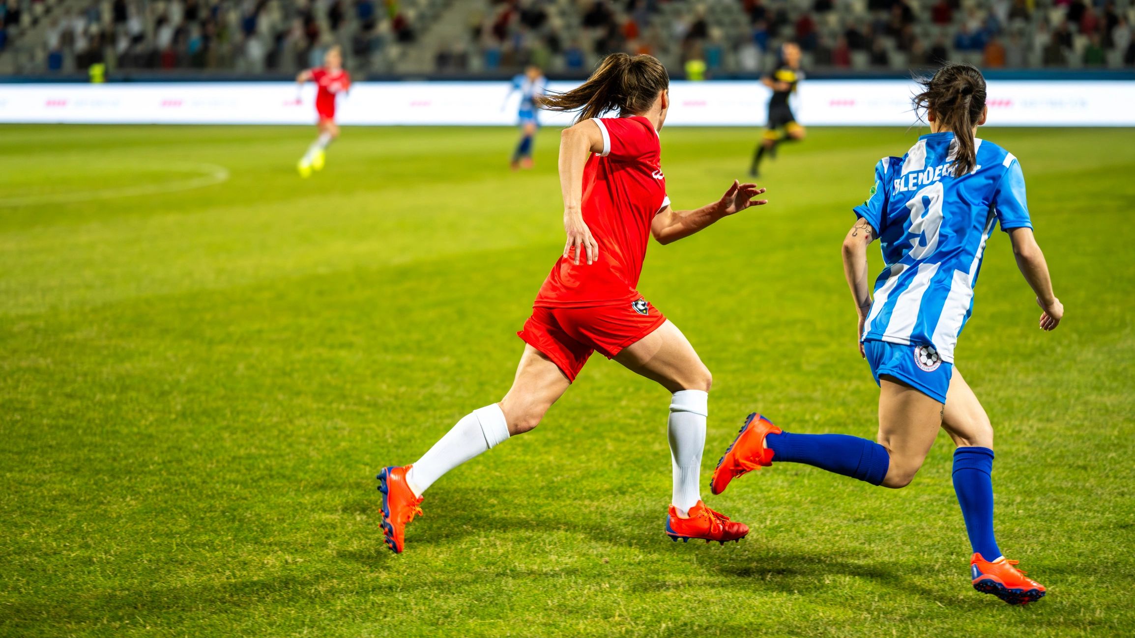 Red Square players running together on the football field