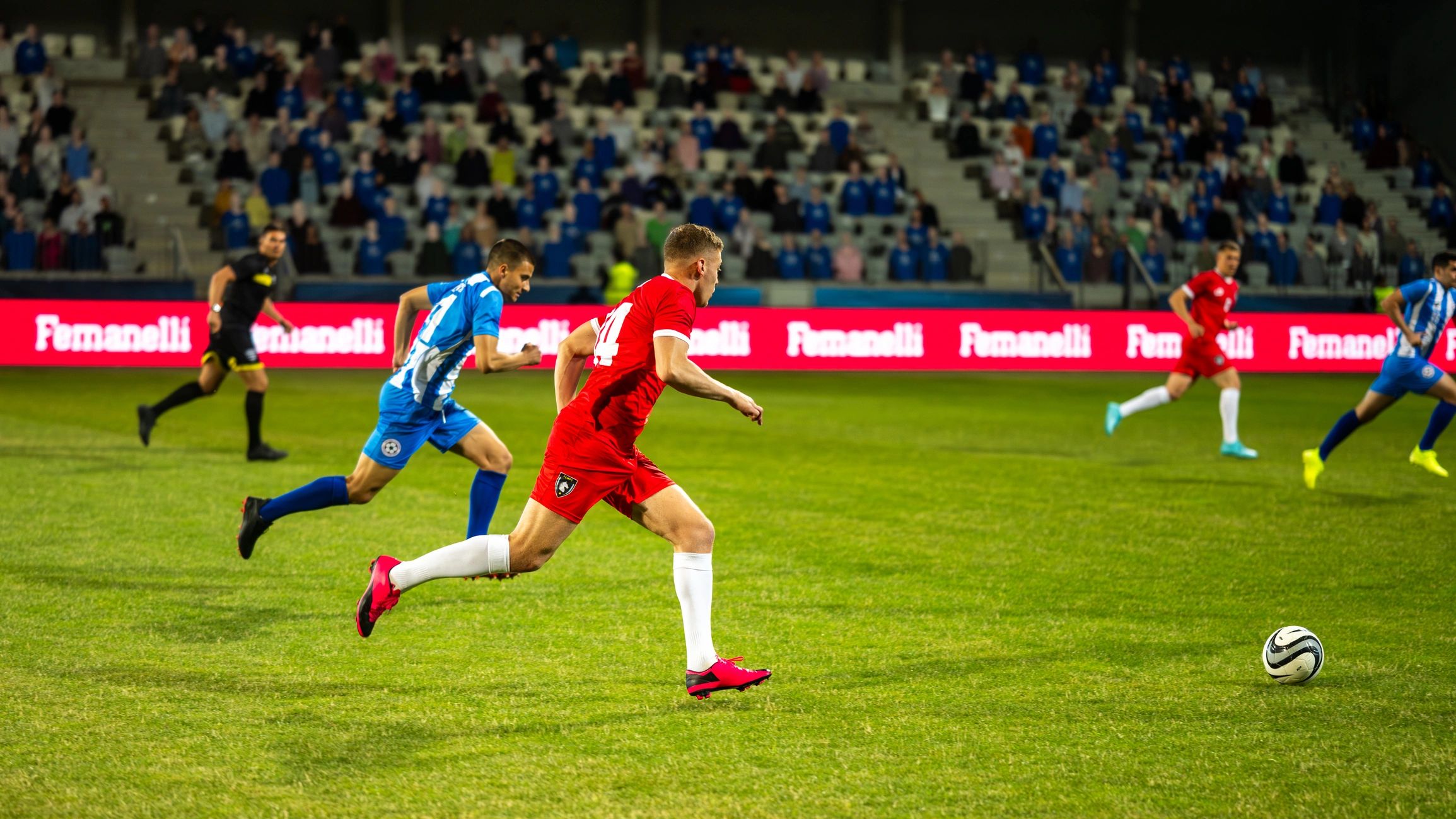 Football players on the pitch in a stadium